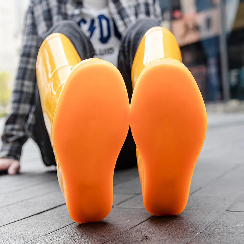White plastic rain boots with high tube design and flat heel for outdoor labour protection