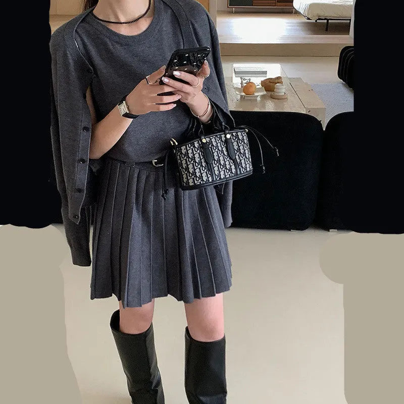 Women's grey knitted vest skirt and long-sleeve cardigan set with 3D pattern and an adjustable waist belt.