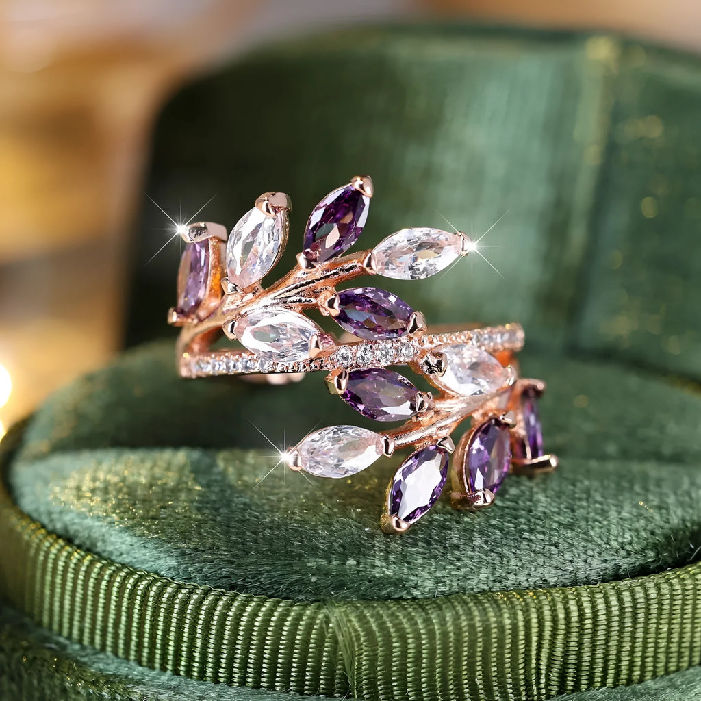 Adjustable copper leaf-shaped ring with sparkling zircon stones in rose gold and platinum finishes.