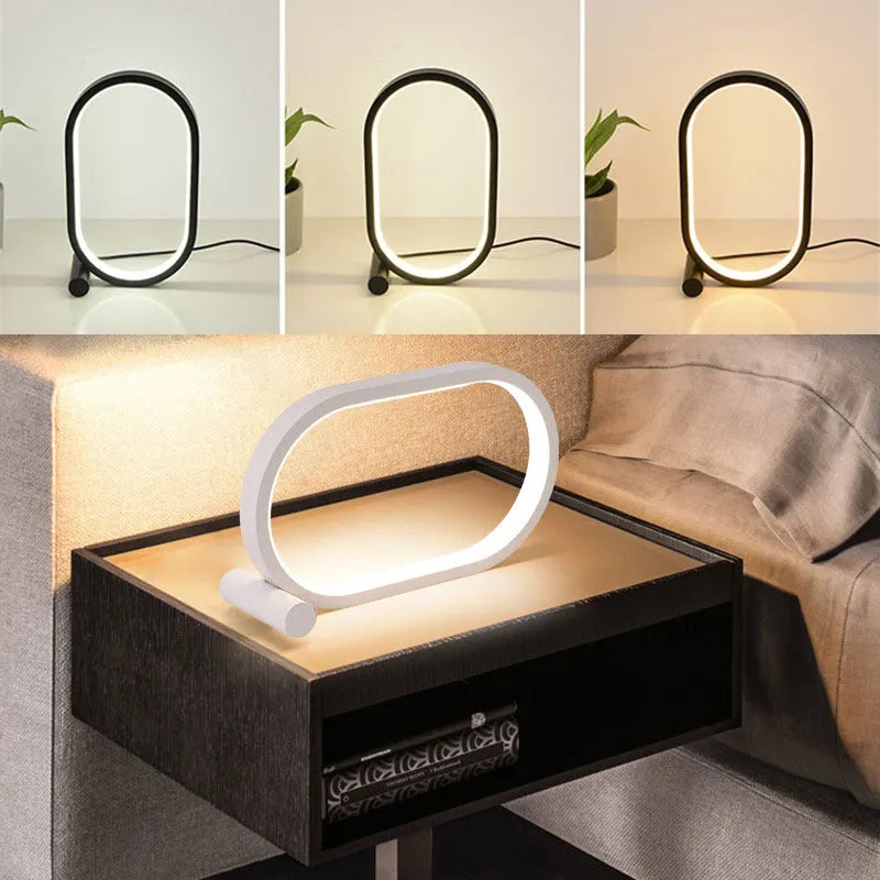 USB plug-in oval acrylic touch dimmable night light with metal base on a desk, black colour