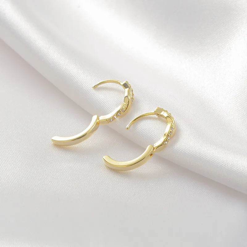 Geometric interwoven hemp rope earclip earrings in a gold or silver copper finish.