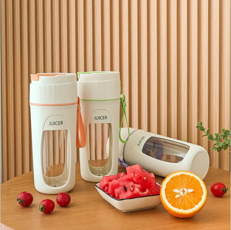 Portable USB electric blender with borosilicate glass cup in fresh orange, grass green, and light purple colours.