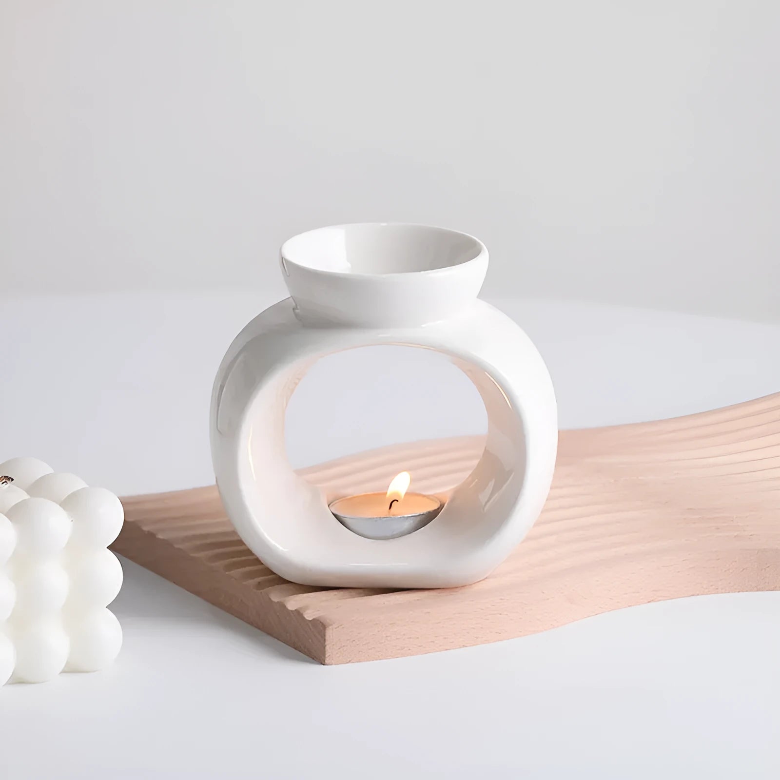 White retro Nordic ceramic aromatherapy stove ornament on a surface.