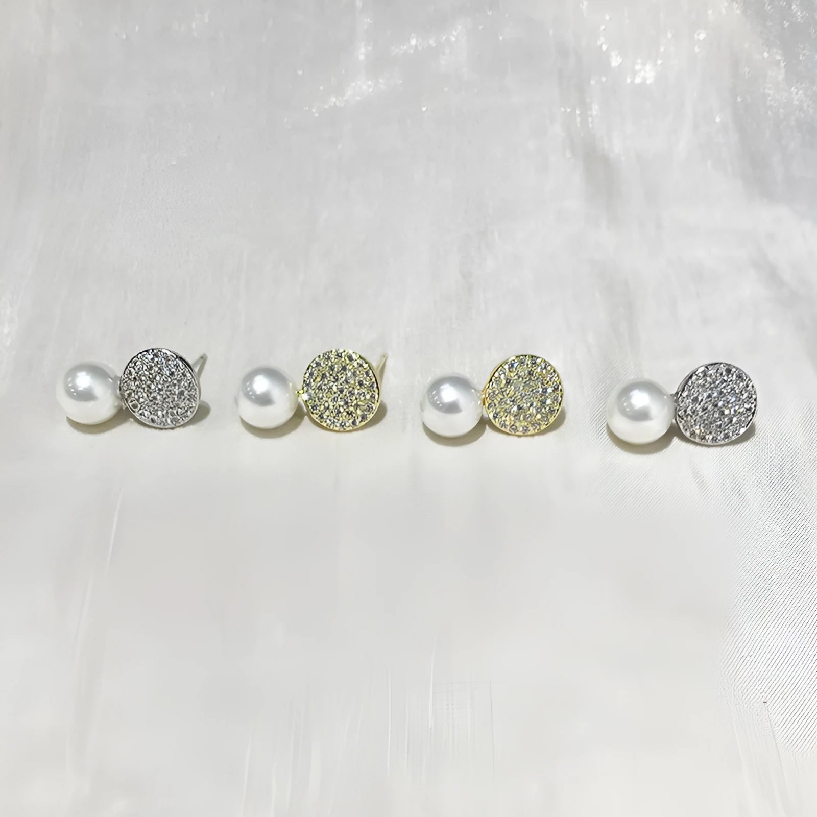 Round diamond studded pearl earrings in gold finish with post back closure