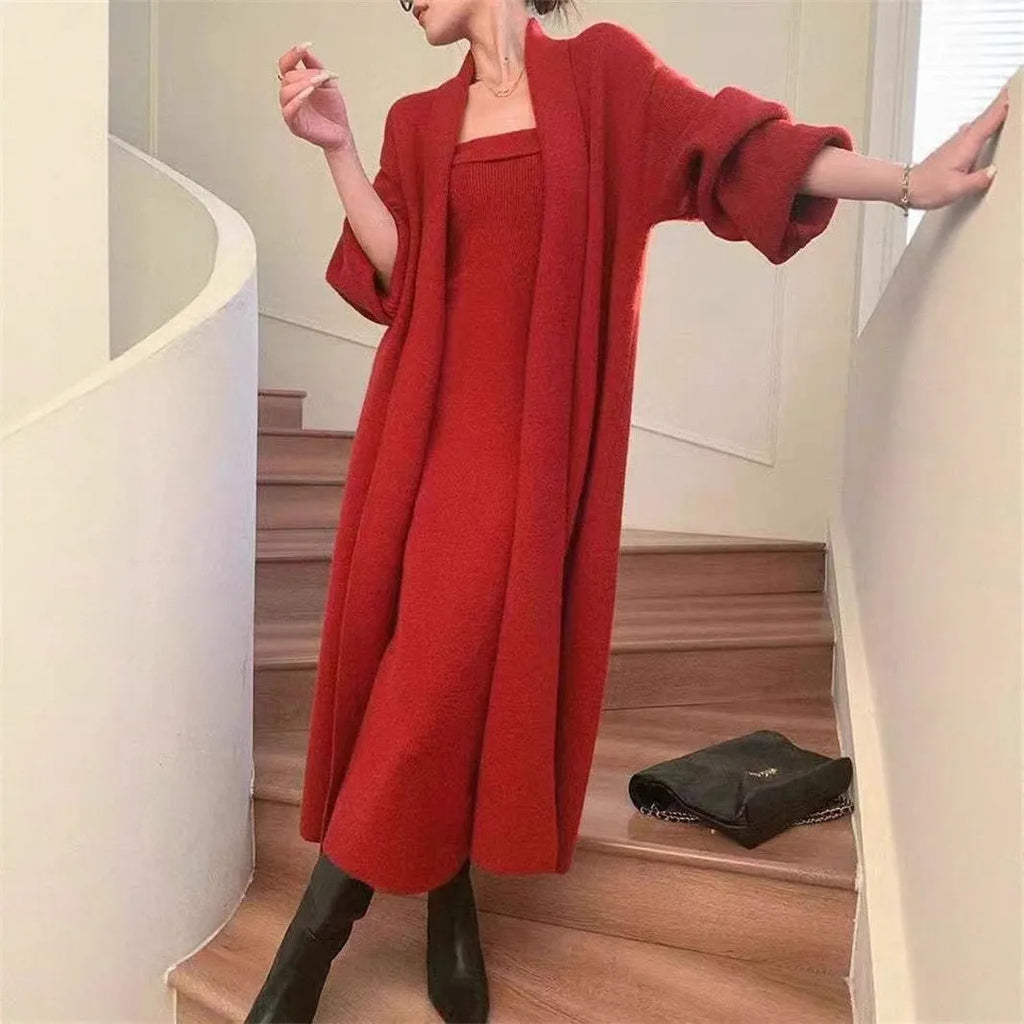 Woman wearing a grey textured flecked long-sleeve dress with a matching open cardigan from a two-piece knit set.