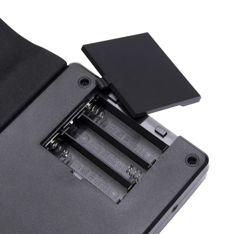 Rolled-up silicone keyboard next to its ABS control panel, packed inside a 28cm black carry case.