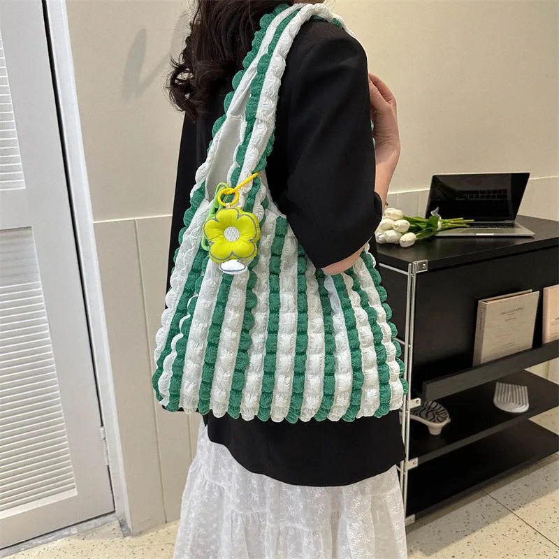 Women's pleated bubble shoulder bag with a floral pendant in soft polyester, shown in a vertical square shape.