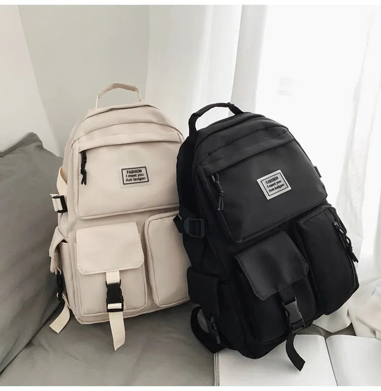 Black or white nylon student backpack with computer compartment and three-dimensional pockets