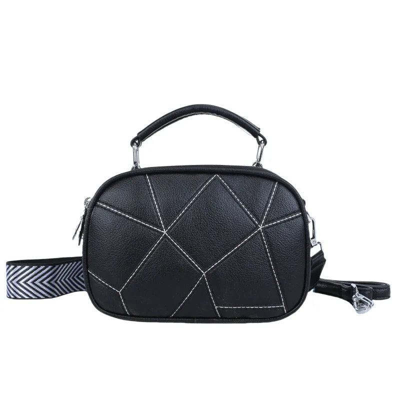 Round PU leather crossbody bag with patchwork design showing decorative stitching