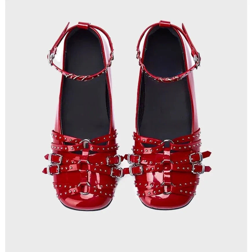 Black women's patent leather buckle pumps with a square toe and flat rubber sole.