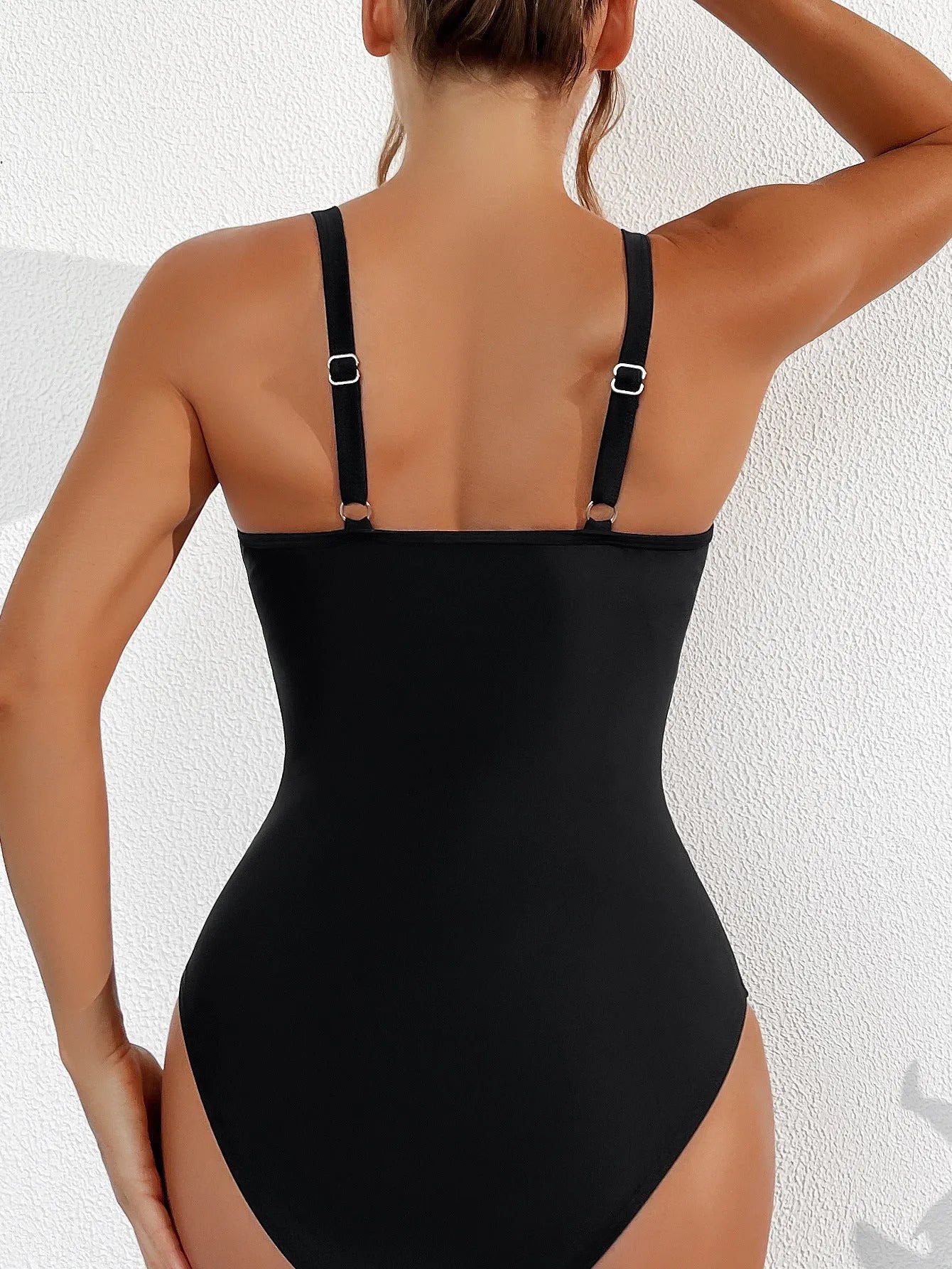 Black women's one-piece swimsuit with halter neck and briefs style, made from nylon fabric