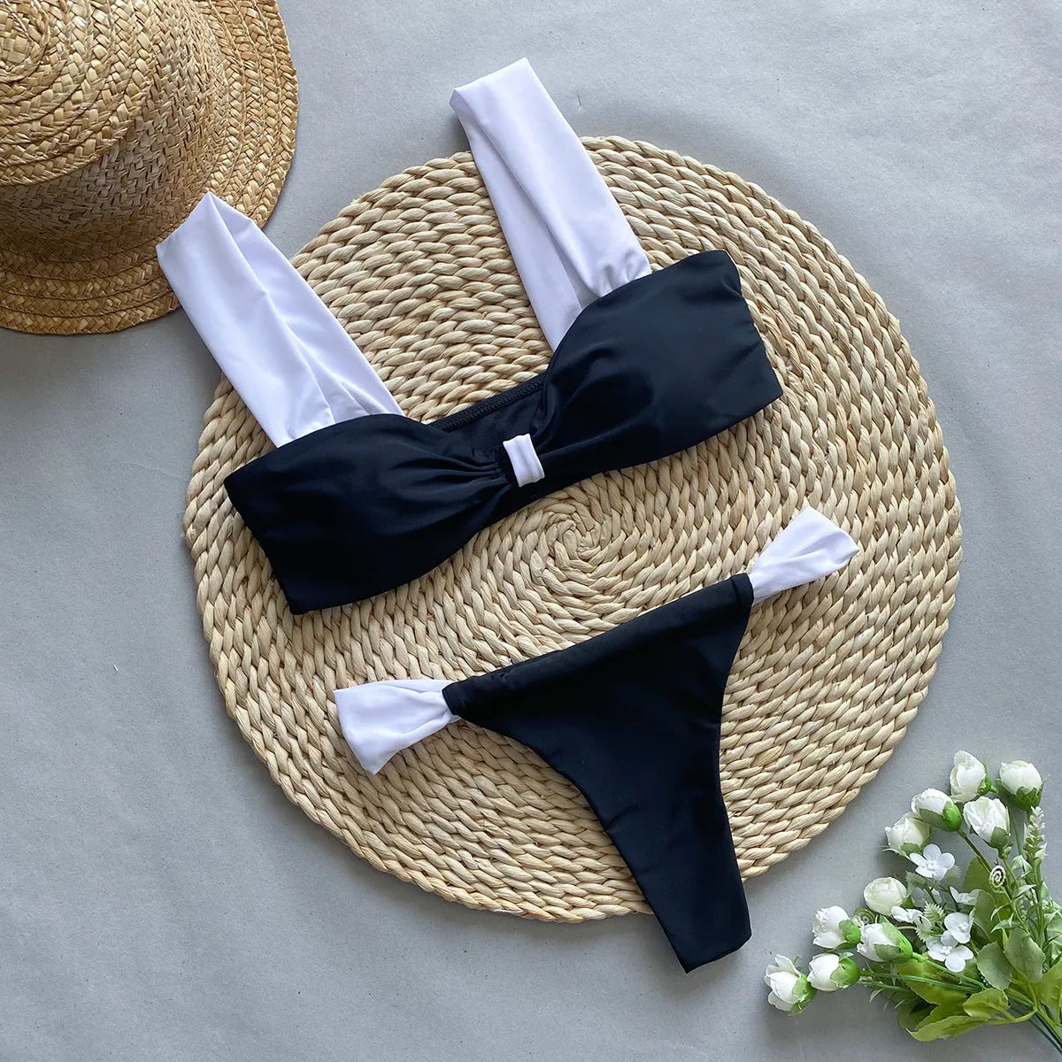Women's black and leopard print tube top bikini set laid flat, showing the sleeveless top and briefs.