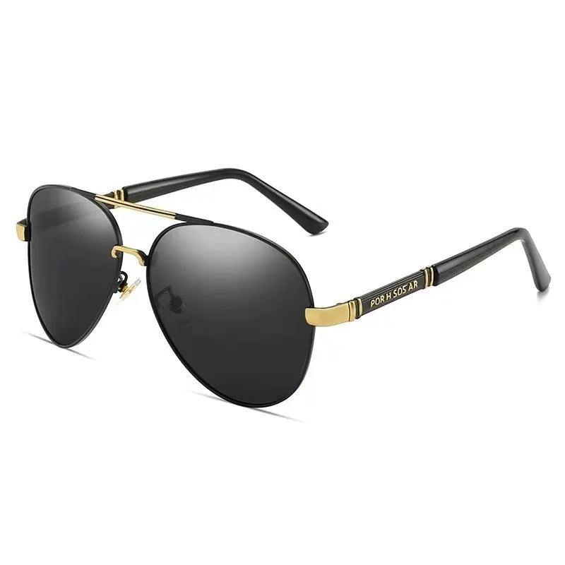 Gold metal frame sunglasses with polarised grey lenses and dragon phoenix temple detail on a table.