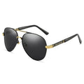 Gold metal frame sunglasses with polarised grey lenses and dragon phoenix temple detail on a table.