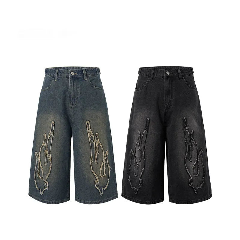 Men's black cropped denim shorts with flame embroidery patch on leg