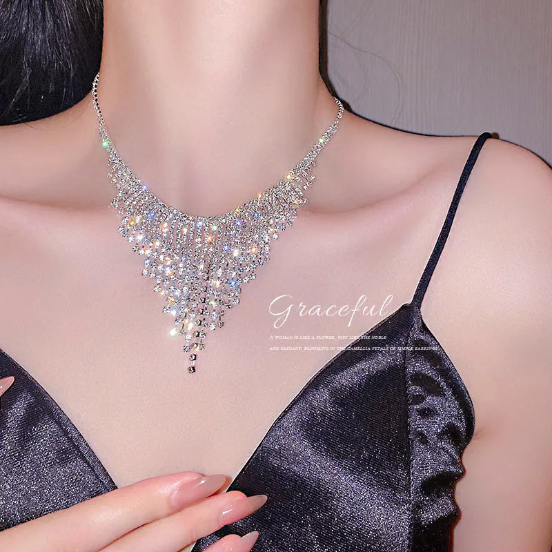 Silver alloy diamond tassel necklace with geometric pendant and ball bead chain on a white background