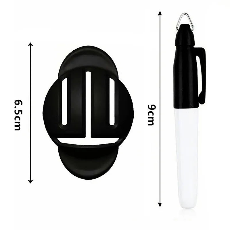 Plastic golf ball alignment scriber tool with drawing pen on a green putting surface