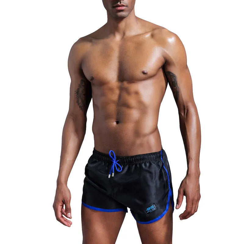 Men's solid colour polyester sports shorts in blue showing smooth beach pants design for fitness and swimming