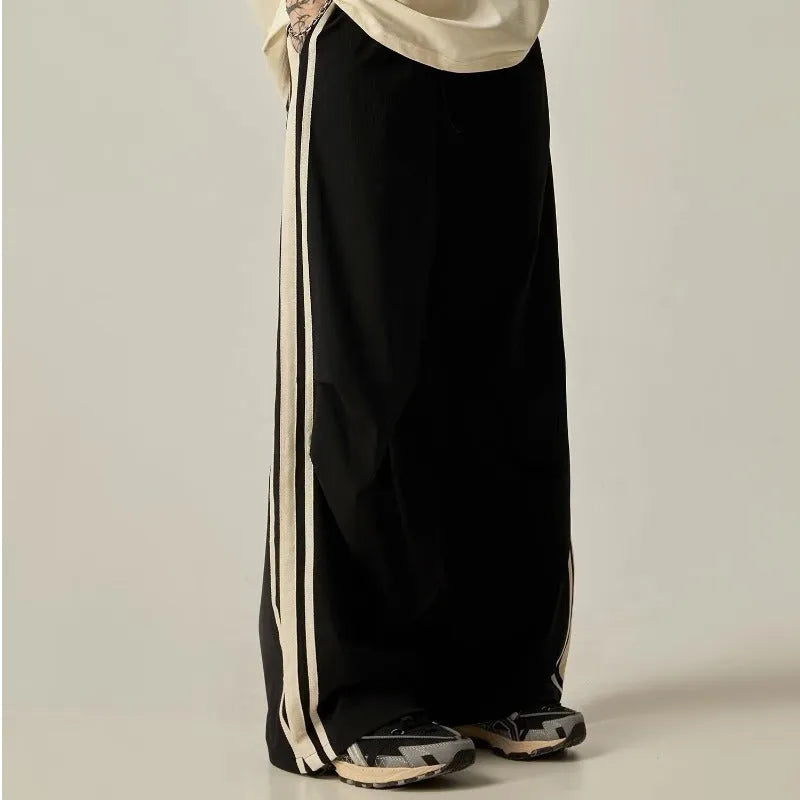 Black men's high-waist wide-leg climbing trousers laid flat, showing straight-leg design.