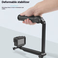 Black folding portable tripod stand for GoPro Hero action cameras on a white background.