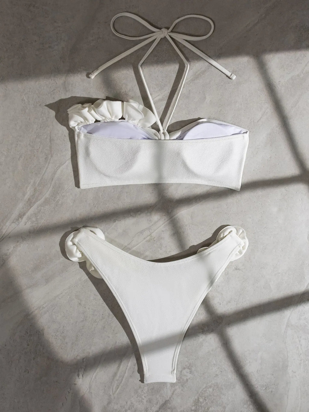 White halter neck lace-up swimsuit bikini with three-dimensional flower pattern.