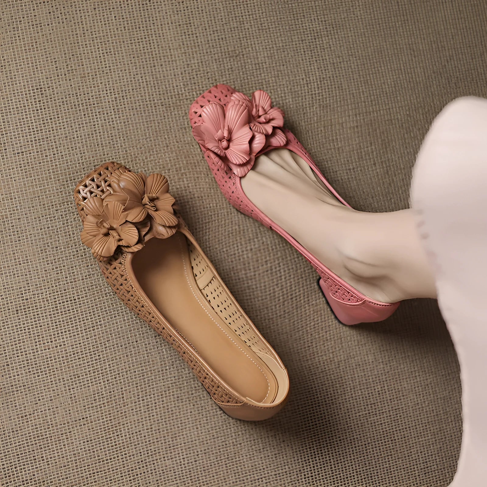 Women's light brown cowhide leather open weave pumps with a mid heel on a neutral background.