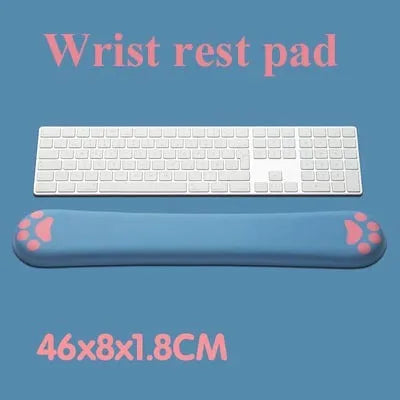 Blue memory foam keyboard wrist support pad on a wooden desk next to a keyboard.