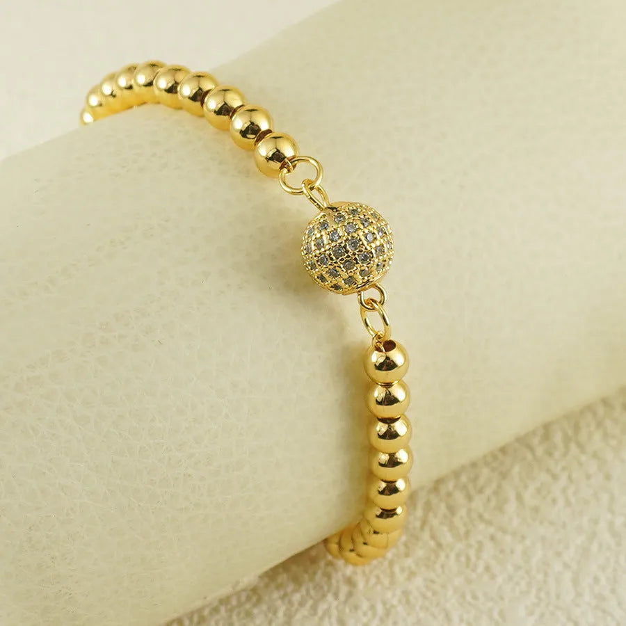 Arabic-style women's copper bracelet with a heart-shaped zircon ornament on a model's wrist.