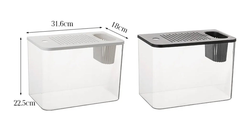 A compact black plastic betta fish tank with a built-in cover, measuring 32cm long, on a wooden table.