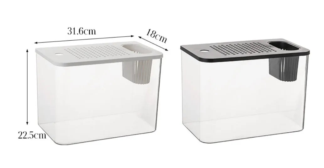 A compact black plastic betta fish tank with a built-in cover, measuring 32cm long, on a wooden table.