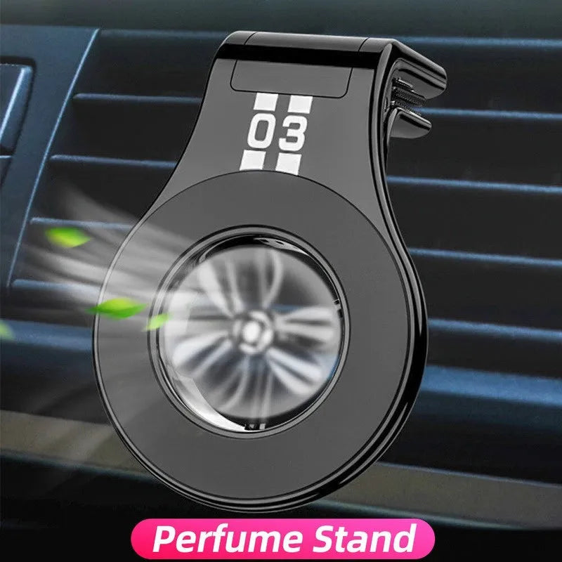 Black magnetic car phone holder clipped to a car air vent, holding a smartphone.