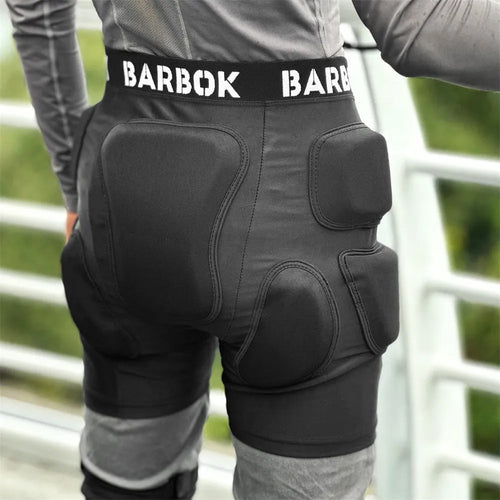 Black adult skating hip protection pad made of spandex and NBR foam on a grey background.