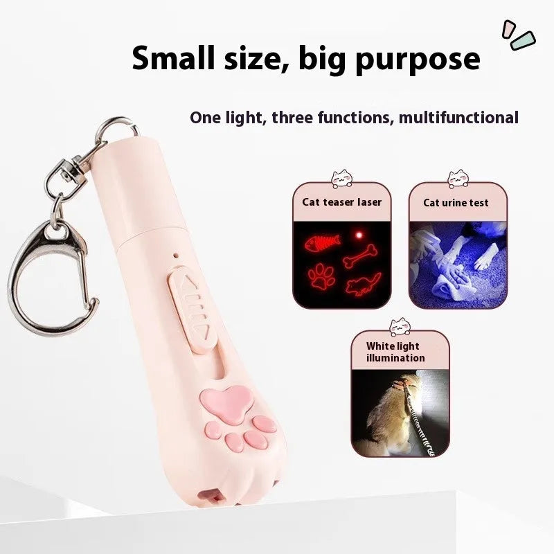 Pink USB-rechargeable cat toy base with a long white feather rotating on a wand, placed on a wooden floor.