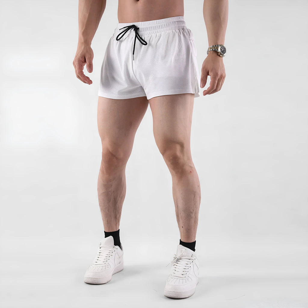 Man wearing black quick-dry nylon summer shorts on a light background