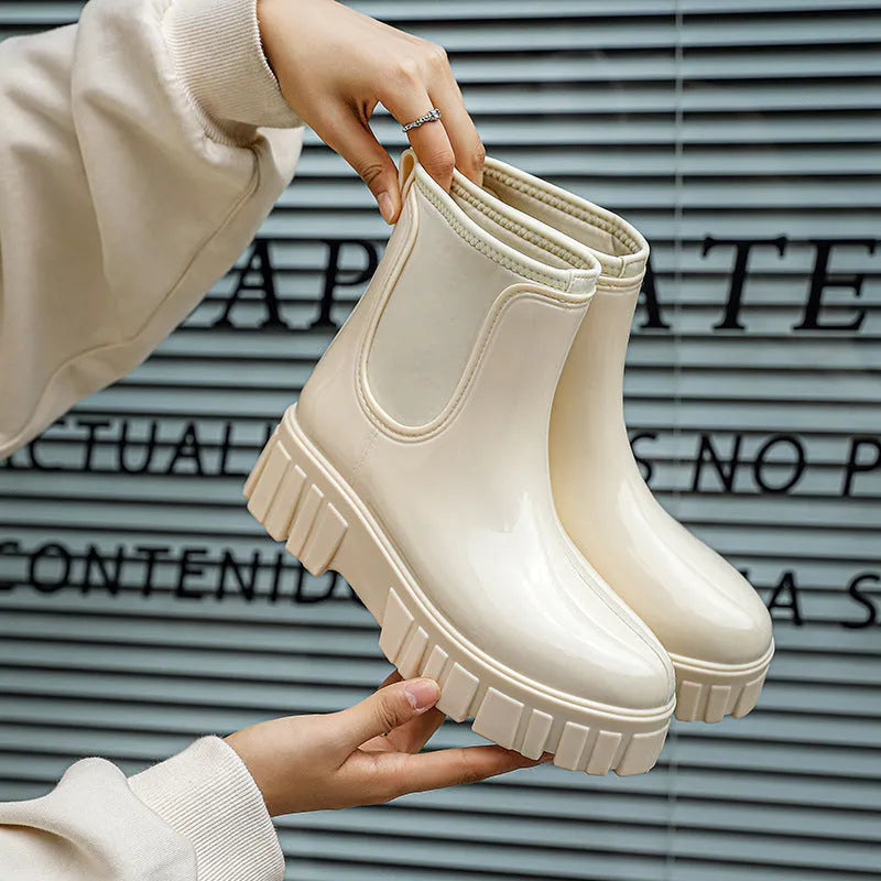 Women's creamy-white PVC low tube rain boots with flat heel and non-slip sole.