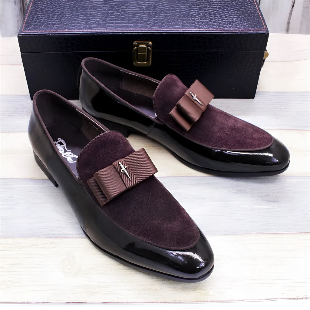 Men's glossy black patent leather low-top shoes with a tassel on a leather toe holder.