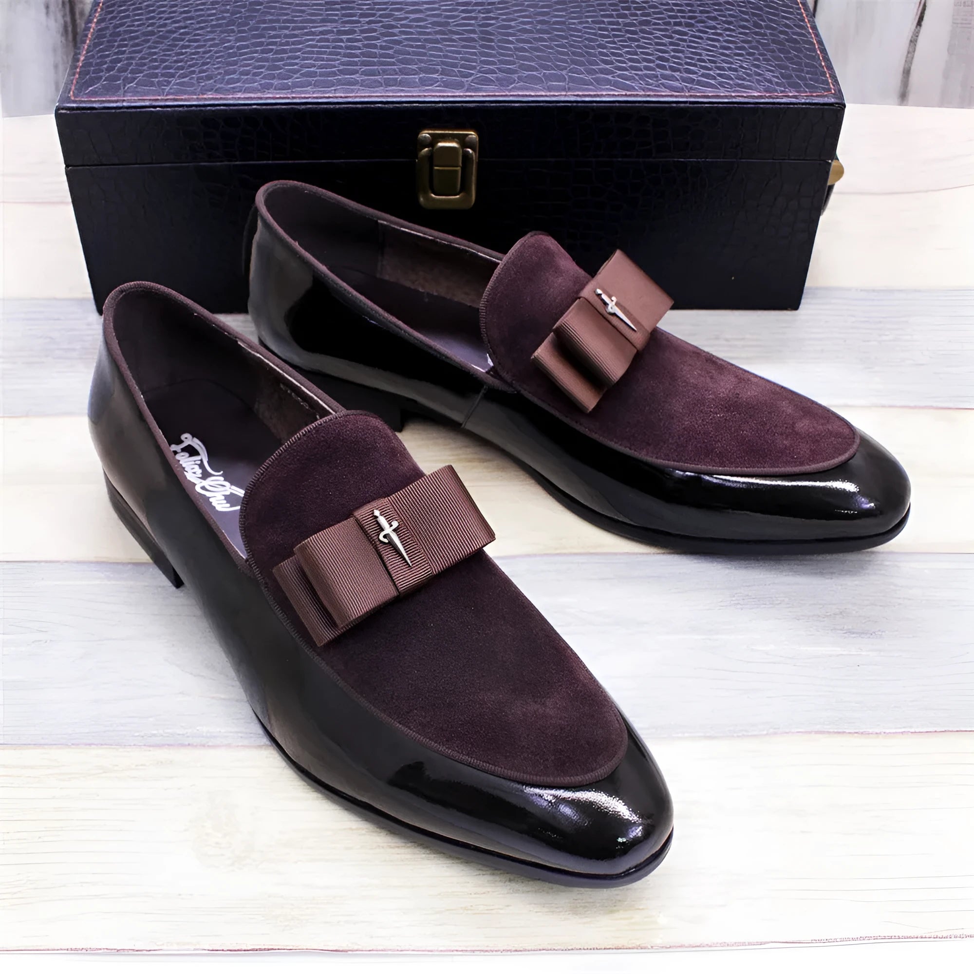 Men's glossy black patent leather low-top shoes with a tassel on a leather toe holder.