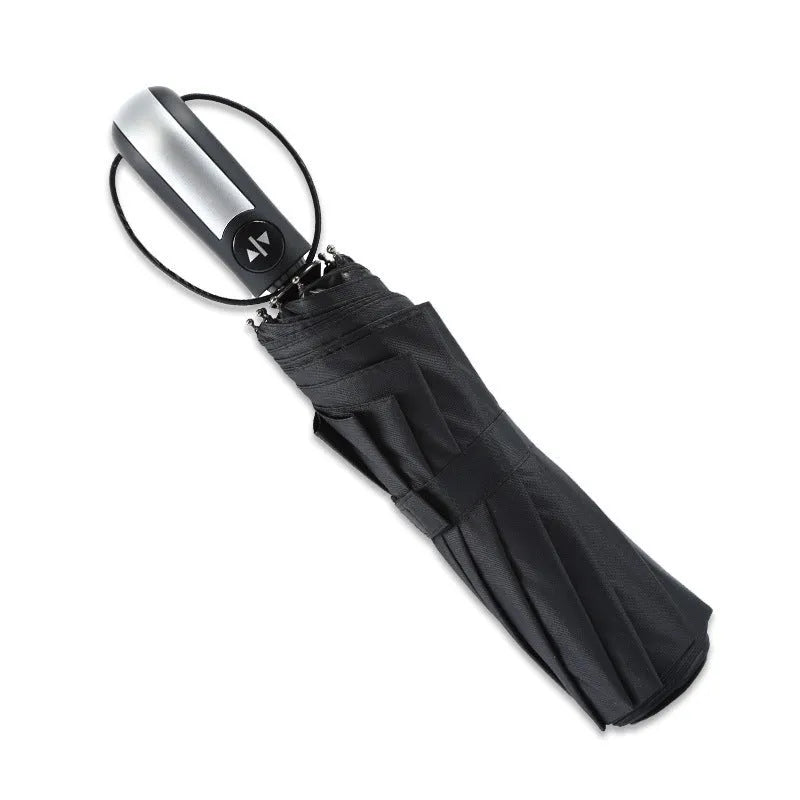 Triple-folding automatic black business umbrella with steel ribs and rubber handle, shown open.