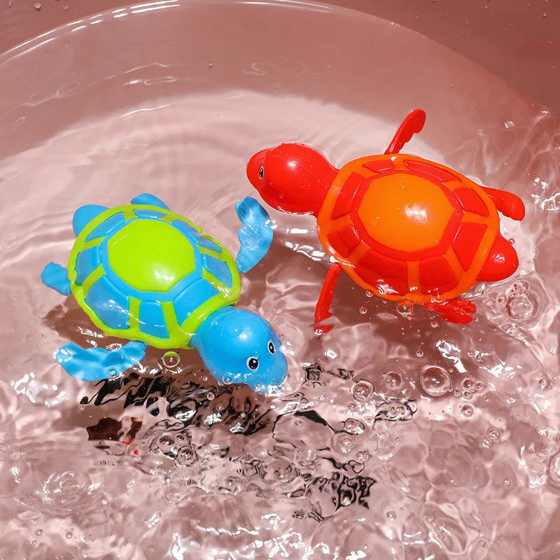 Small green plastic swimming turtle bath toy floating in water