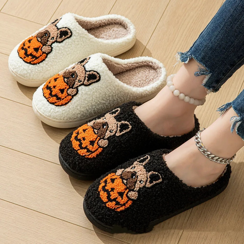 Black and white Halloween slippers with pumpkin pattern, plush upper, and textured rubber sole.