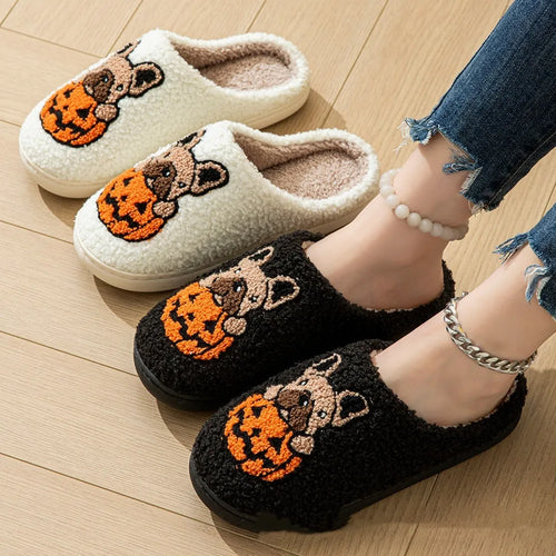 Black and white Halloween slippers with pumpkin pattern, plush upper, and textured rubber sole.