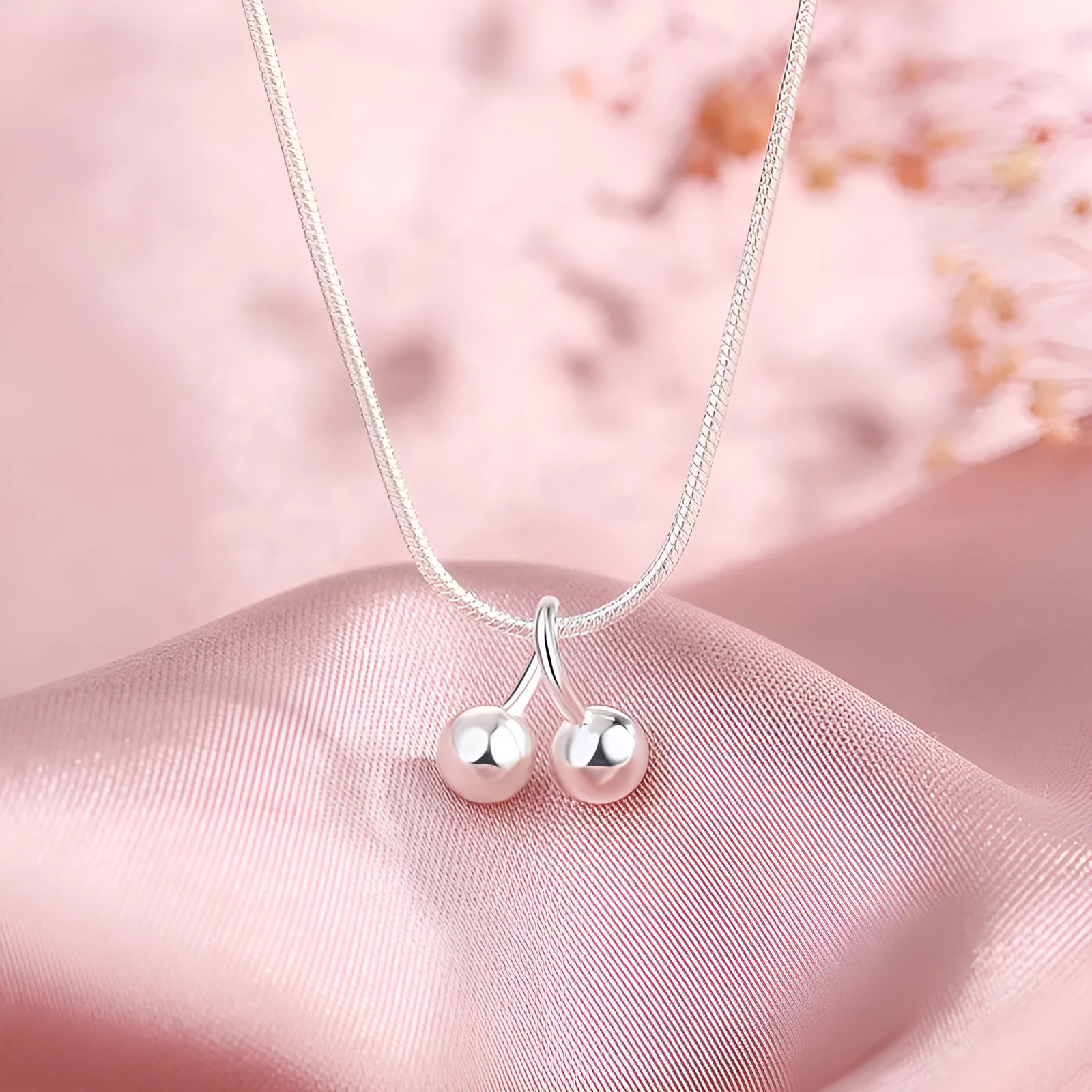 Silver cherry fruit pendant necklace on an adjustable snake bone chain for women.