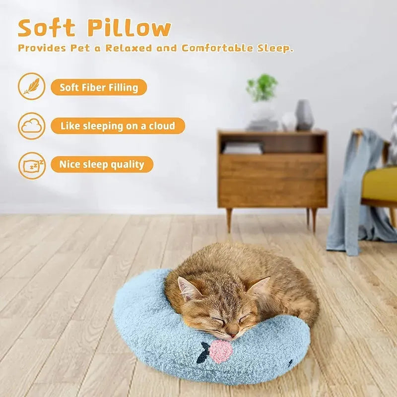Small white U-shaped plush pillow for a cat or small dog, showing its half-donut shape with a raised rim.