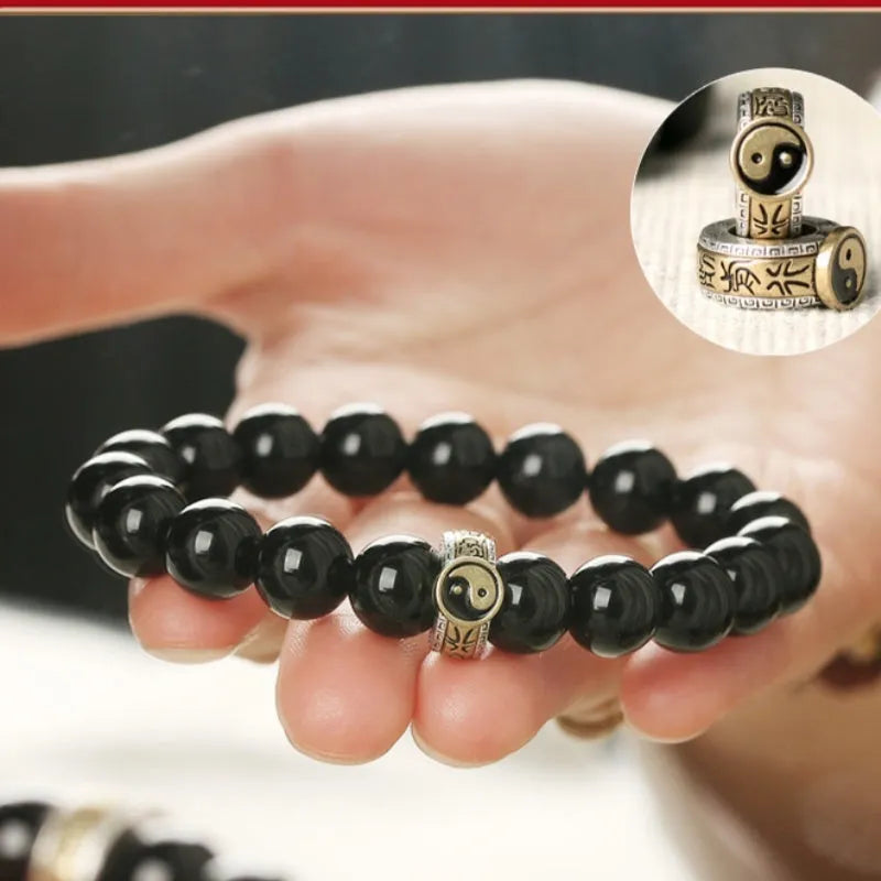 Black stone single ring bracelet for men and women on a wrist, showing 10mm and 12mm size options.