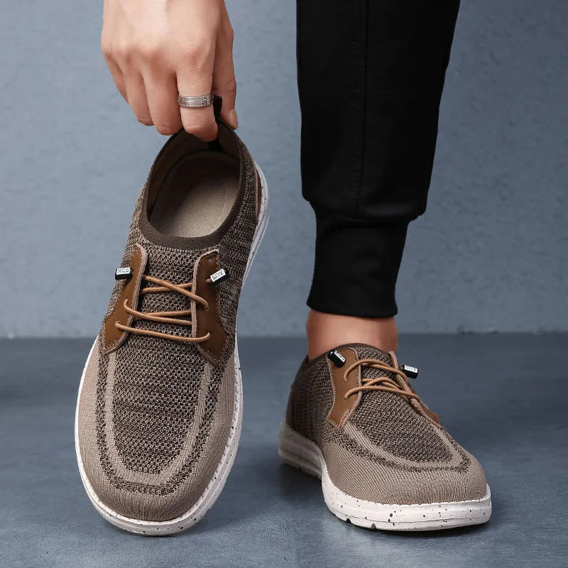 Men's black laceless canvas slip-on casual shoes with a round toe and rubber sole.