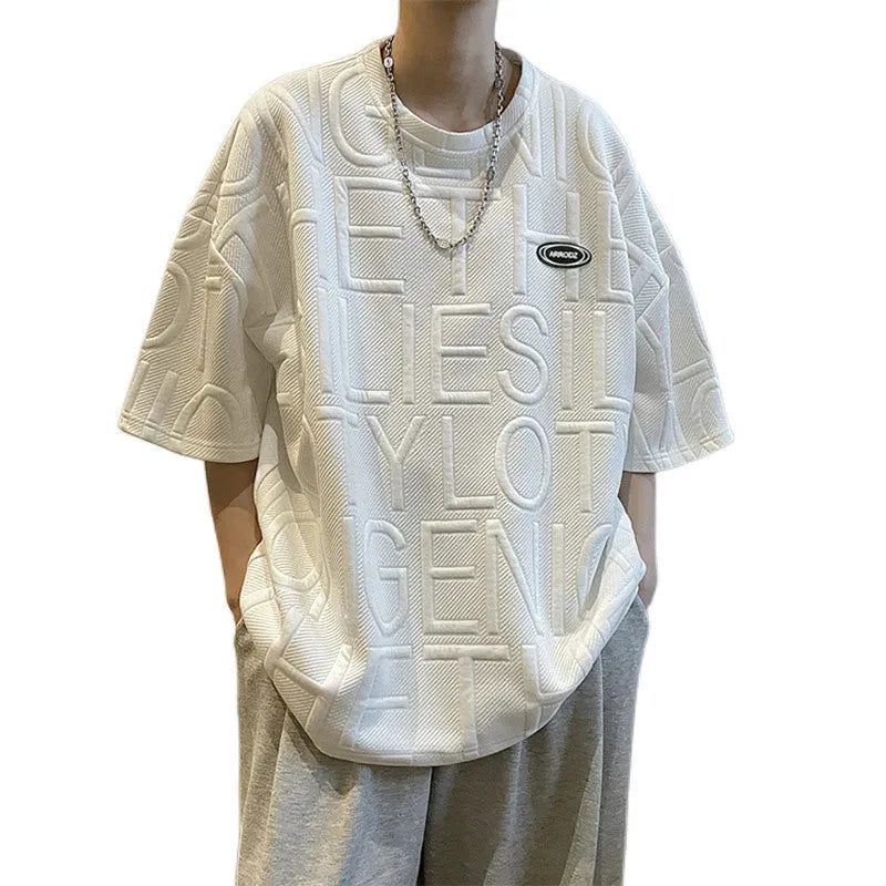 Men's grey t-shirt with a raised 3D letter print on the chest, showing a retro loose fit.