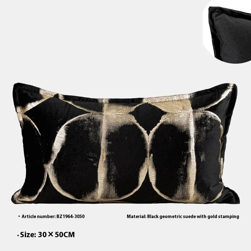 Black and gold abstract pattern flannel pillow cushion on a sofa, shown with removable cover.