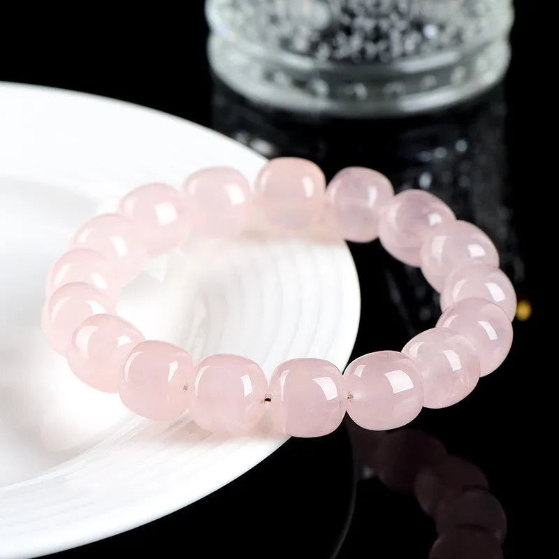 Pink unisex crystal bracelet with geometric barrel beads measuring 11-12 mm.