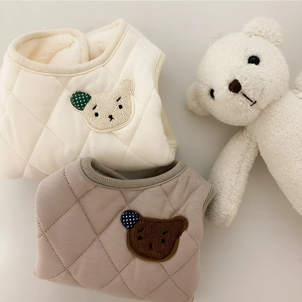 Quilted pet vest with bear patch embroidery on cream background for small dogs