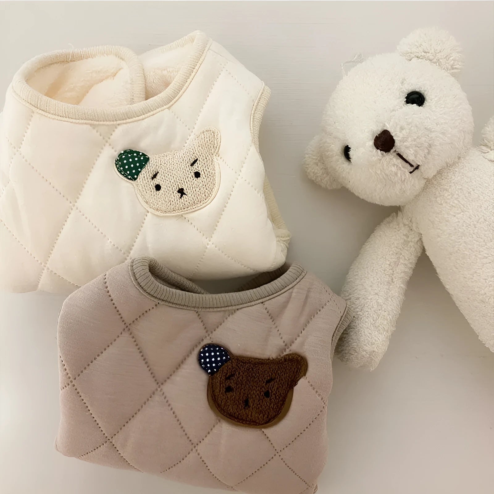 Quilted pet vest with bear patch embroidery on cream background for small dogs